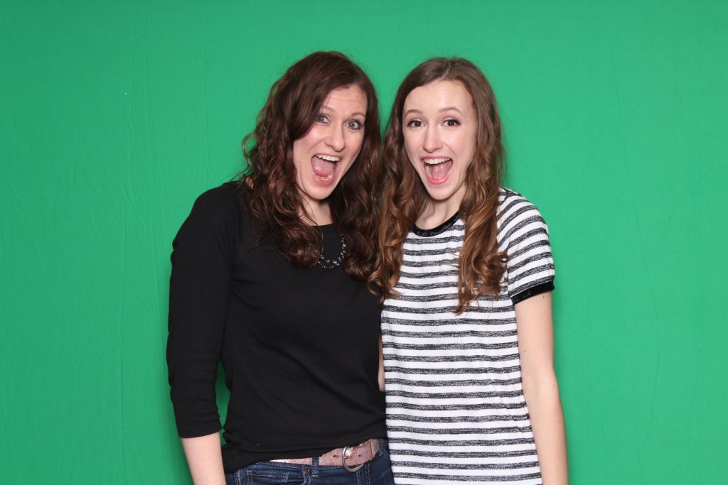 Photo booth guests in front of chroma key green backdrop